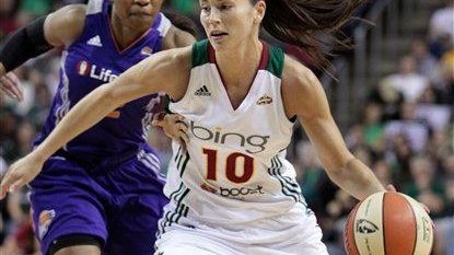 Seattle's Sue Bird dribbles past Phoenix's Temeka Johnson