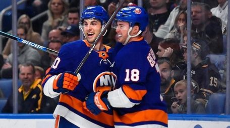 Islanders center Derick Brassard, left, celebrates his goal