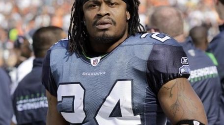 Seattle Seahawks running back Marshawn Lynch watching from