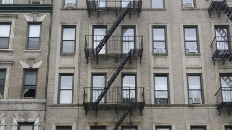 Exterior of 142 West 109th Street (center with
