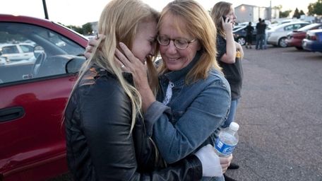 Emma Goos, 19, hugs her mother, Judy Goos,