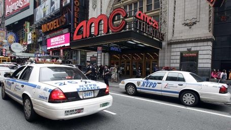 Police officers outside an AMC movie theater screening