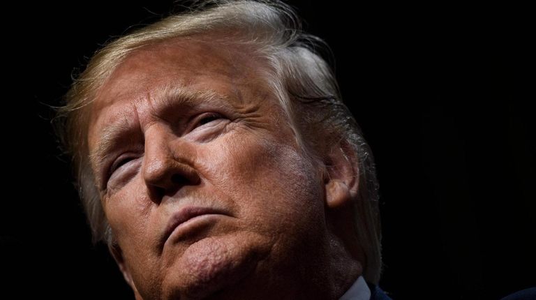 President Donald Trump pauses while speaking to the