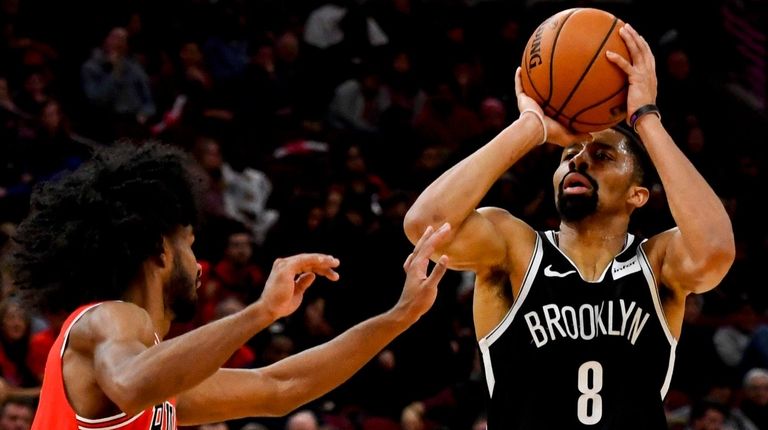Nets guard Spencer Dinwiddie shoots next to Chicago