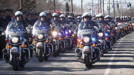 Motorcycles from various departments lead the funeral persession