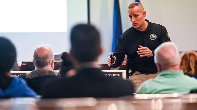 Suffolk County Police Det. Clifford Lent leads a