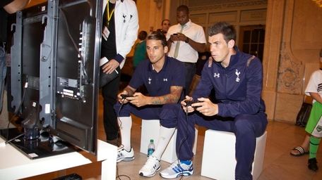 Tottenham Hotspur players check out a demo of