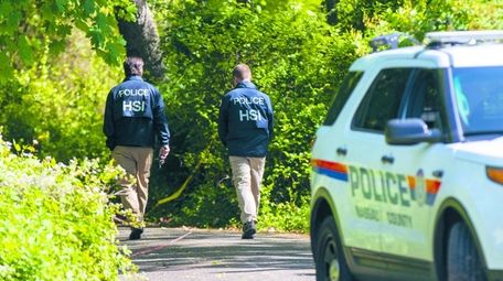 Nassau County police and federal investigators at the
