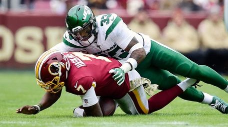 Dwayne Haskins of the Redskins is sacked by