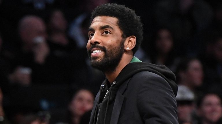 The Nets' Kyrie Irving looks on during a