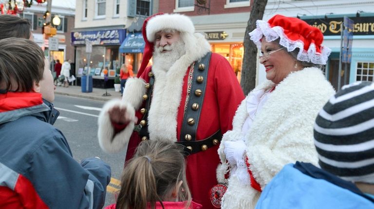 Santa Claus and Mrs. Claus greet a group