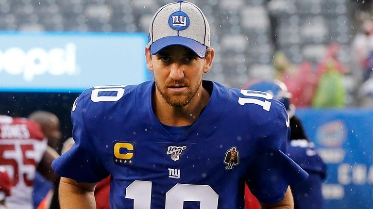 Eli Manning trots off field earlier this season.