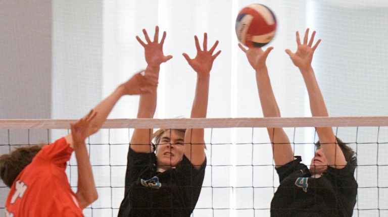 Westhampton's Michah Terry, center, and Luke Farnan, right,