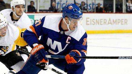 Anders Lee of the Islanders controls the puck