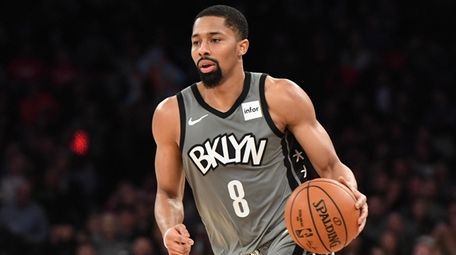 Nets guard Spencer Dinwiddie dribbles the ball upcourt