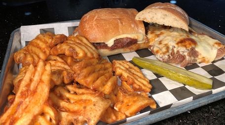 A brisket mozzarella sandwich with a side of