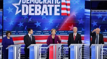 Sen. Elizabeth Warren (D-MA) (C) speaks as Sen.