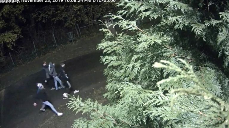 An image from surveillance video shows four people