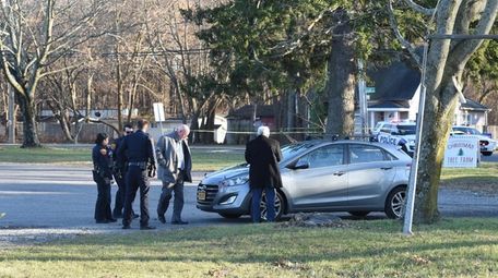 Investigators probe a vehicle in which a man