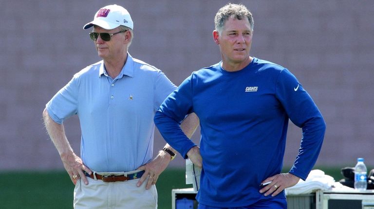 When Giants co-owner John Mara, left, stood with