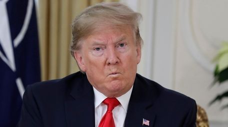 President Donald Trump grimaces during a meeting with