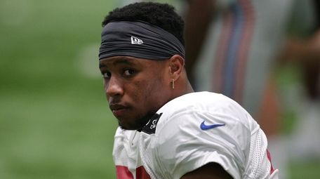 Giants running back Saquon Barkley stretches before practice
