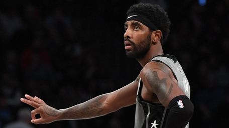 Nets guard Kyrie Irving gestures against the Pelicans