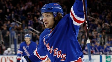Artemi Panarin of the Rangers celebrates after assisting