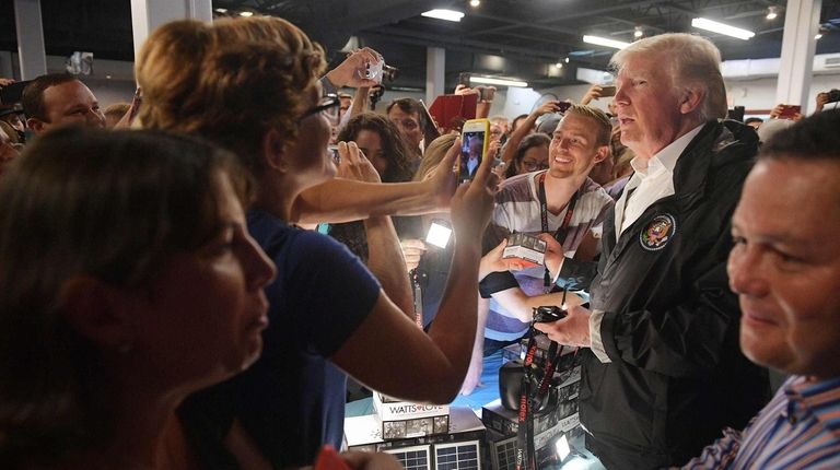 President Donald Trump speaks to people as he