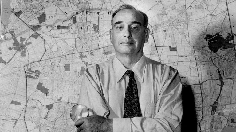 Robert Moses in front of a map of