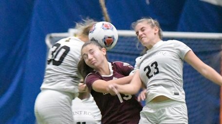 Molloy's Angela Careddu, center, heads the ball between