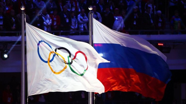 The Olympic flag (L) and the Russian flag