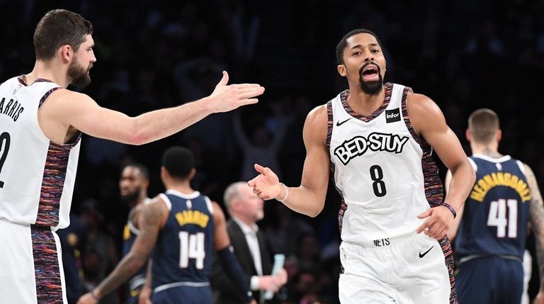 Nets guard Spencer Dinwiddie slaps five with forward