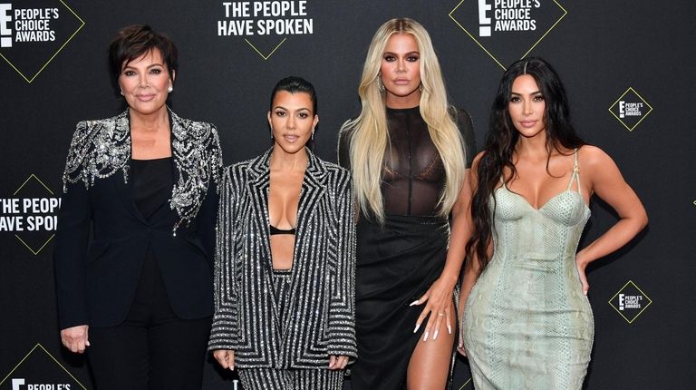 Kourtney, left, Khloé and Kim Kardashian attend the