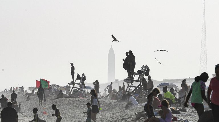 Beachgoers enjoys the waves in the evening at
