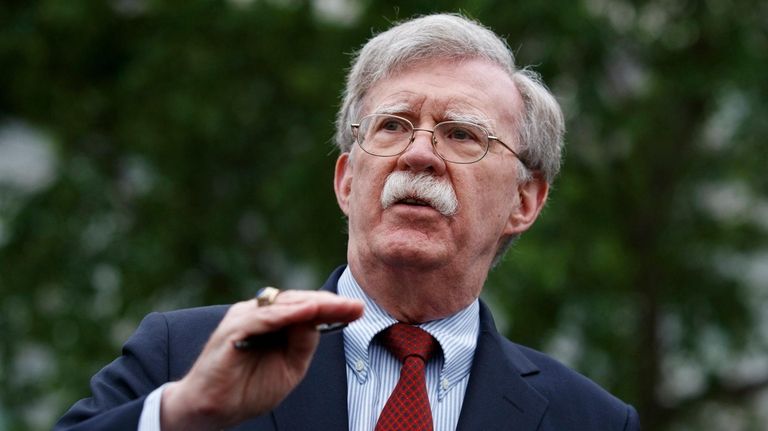 National security adviser John Bolton talks to reporters