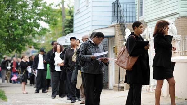 People seeking jobs wait to speak to over