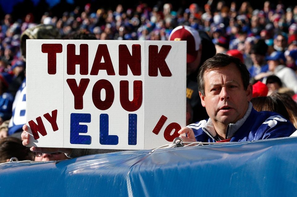 A fans holds a banner in reference to