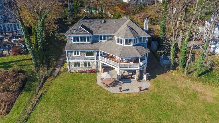A custom-built, three-story Centerport home with twin piers