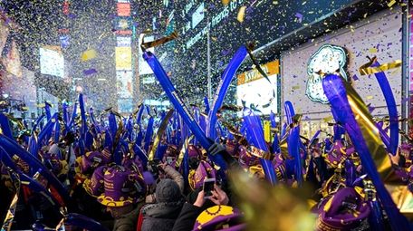 Falling confetti helps revelers ring in the New