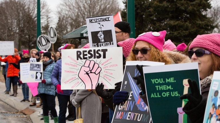 Participants direct their signs toward traffic during the