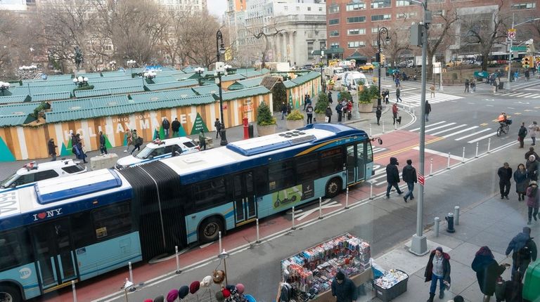 A bus travels along a crosstown route on