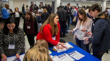 Job applicants attend a job fair last month
