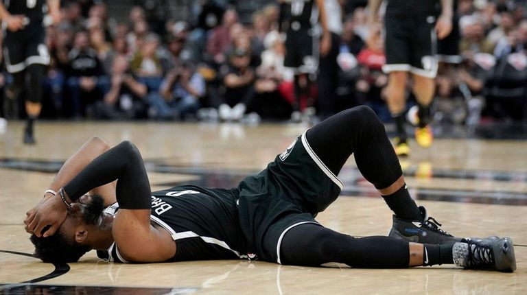 Brooklyn Nets' David Nwaba lies injured on the
