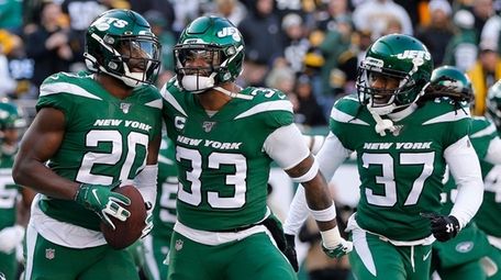 Marcus Maye of the Jets, left, celebrates his