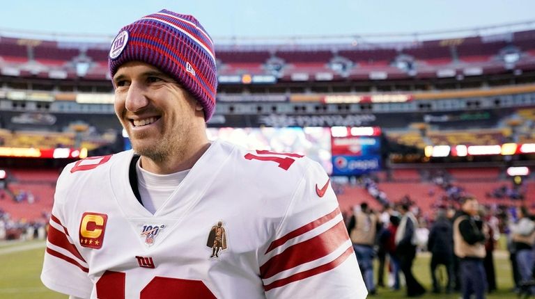 Eli Manning of the Giants walks off the