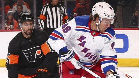 Brendan Lemieux of the Rangers controls the puck