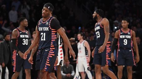Knicks guard Damyean Dotson and teammates react with