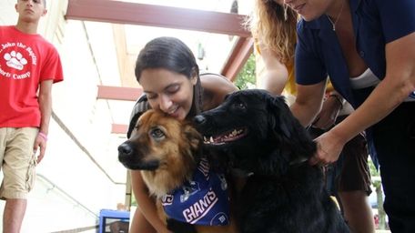 Jasmine Saburro, 18, of Yaphank, hugs her dog
