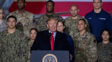 President Donald Trump speaks on stage during the